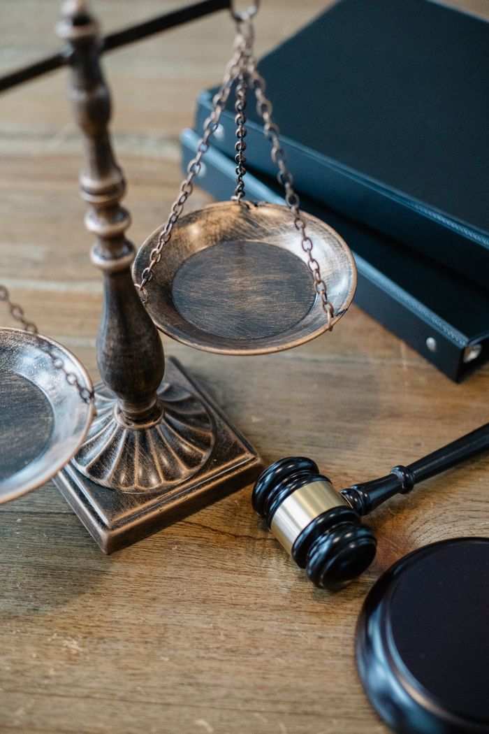 Home From above of judicial symbols consisting of Scales of Justice and small judge hammer with curly handle